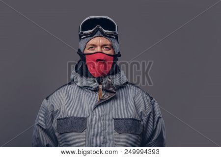 Portrait Of A Snowboarder Dressed In A Full Protective Gear For Extream Snowboarding Posing At A Stu