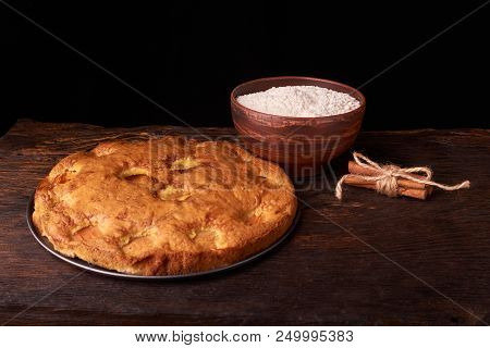 On A Dark Wooden Table, Fashionable Bakeries, A Bowl With Flour, Apricot Cake And Tools