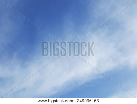 Cirrus Clouds In The Blue Sky. Sky With Thin Clouds. Background With Cirrus Clouds On A Sunny Day.