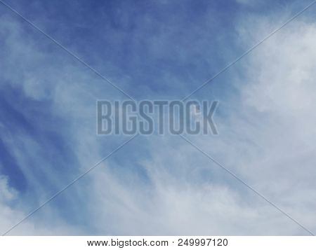 Cirrus Clouds In The Blue Sky. Sky With Thin Clouds. Background With Cirrus Clouds On A Sunny Day.
