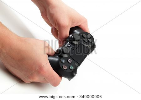 Russia, Oktober 24 2019: Mans Hands Holding  New Sony Dualshock 4 With Playstation 4. Sony Playstati