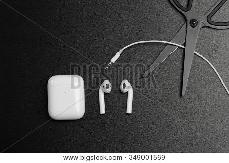 Air Pods. With Wireless Charging Case. New Airpods 2019 On Dark  Background. Airpods. Female Headpho