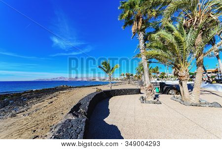 Puerto Del Carmen Beach In Lanzarote, Canary Islands, Spain. Blue Sea, Palm Trees, Selective Focus