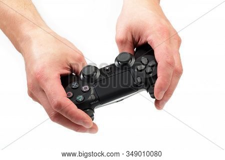 Russia, Oktober 24 2019: Mans Hands Holding  New Sony Dualshock 4 With Playstation 4. Sony Playstati