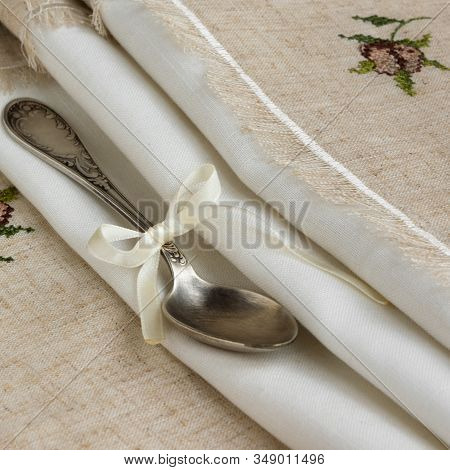 Vintage Russian Silverspoon With Silk Ribbon On Linen Napkin. Old Fashion Heroloom Silverware