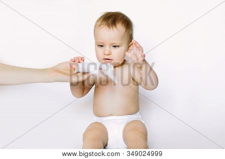 Hygiene - Young Momy Wiping The Baby Skin With Wet Wipes. Little Baby Girl In Diaper Sitting And Tak