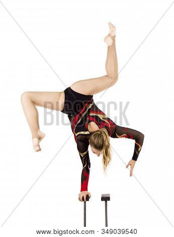 Beautiful Equilibrist In A Red And Black Suit, Performs Exercises On Acrobatic Canes.
