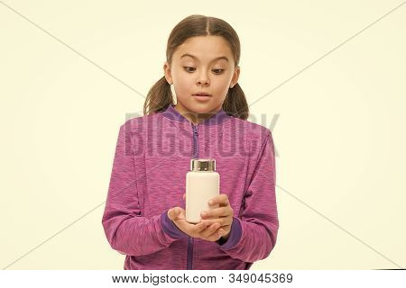 Keep Away From Kids. Little Girl Interested. Small Child Isolated On White. Pills For Healthy Growth