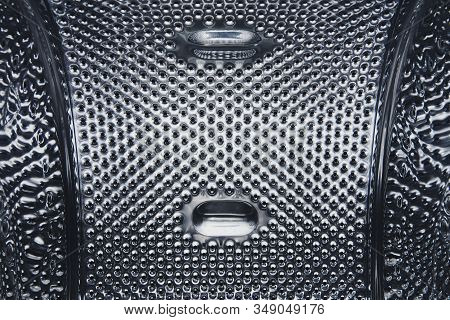 Metal Surface Of The Washing Machine Drum. Inside Of An Empty Washing Machine. Stainless Steel Sampl