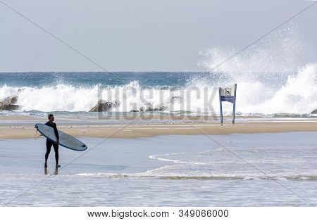 The No Swimming Sign Set Against The Stormy Sea