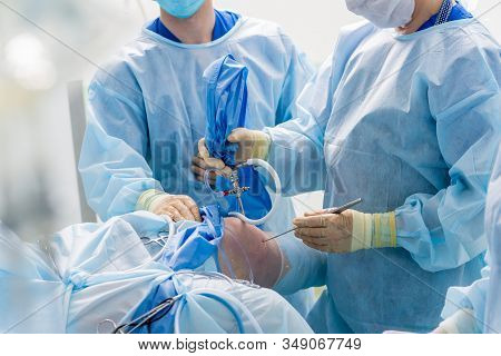 Arthroscope Surgery. Orthopedic Surgeons In Teamwork In The Operating Room