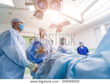 Arthroscope Surgery. Orthopedic Surgeons In Teamwork In The Operating Room
