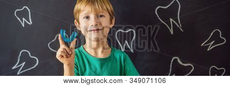 Banner, Long Format Six-year Old Boy Shows Myofunctional Trainer. Helps Equalize The Growing Teeth A