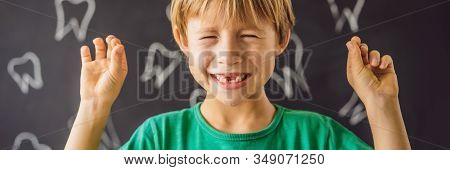 Litle Caucasian Boy Holds A Dropped Milk Tooth Between His Fingers And Laughs Looking Into The Camer