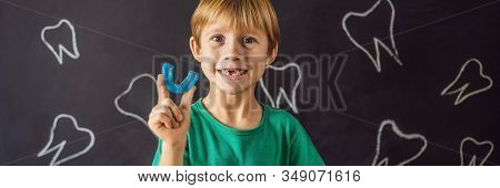 Banner, Long Format Six-year Old Boy Shows Myofunctional Trainer. Helps Equalize The Growing Teeth A