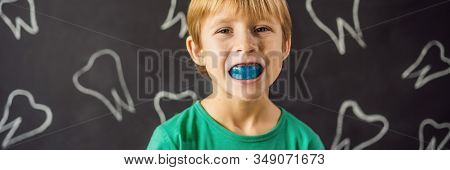 Banner, Long Format Six-year Old Boy Shows Myofunctional Trainer. Helps Equalize The Growing Teeth A