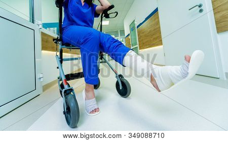Patient On Rollator With Hand Brakes Moving In Hospital
