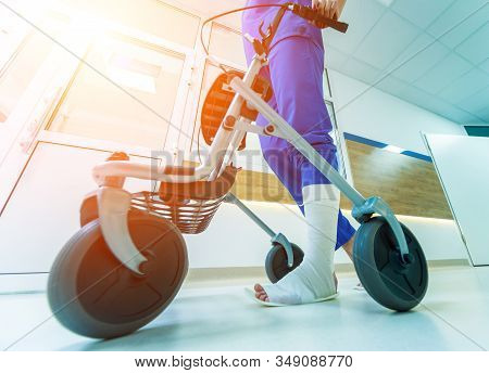 Patient On Rollator With Hand Brakes Moving In Hospital