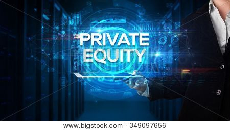 Young business person working on tablet and shows the inscription: PRIVATE EQUITY, business concept