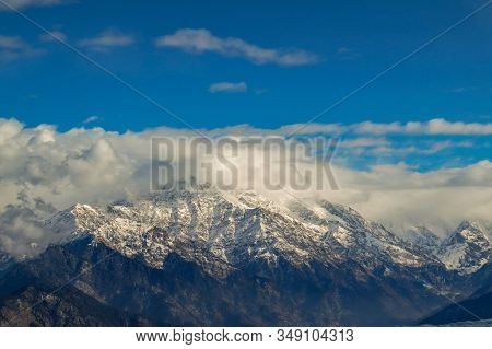 A Series Of Himalayan Mountain In Garhwal Range Against Clouds And Sky