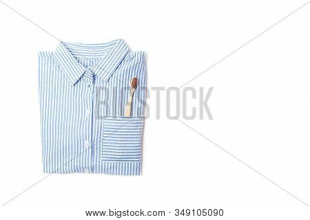 Pajamas Shirt And Wooden Toothbrush On A White Background
