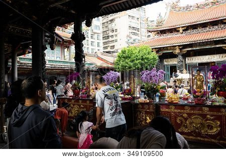 Taipei, Taiwan - October 20th, 2019: people praying in Lungshan temple at Taipei, Taiwan