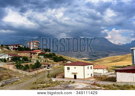 Mountain Houses With Clouds On The Sky, Turkey