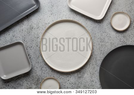 Crockery, Clayware, Empty Grey Modern Utensils And Different Stuff On Grey. View From Above. Space F