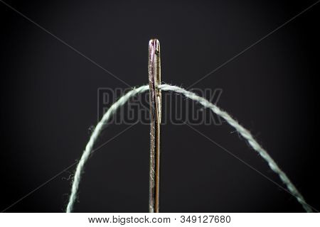 Thread Stuck In A Needle Close-up On A Black Background