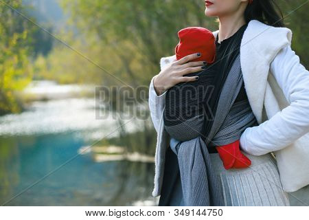 Beautiful Young Mother With Her Infant Baby In Sling Outdoor. Mother Is Carrying Her Child And Trave