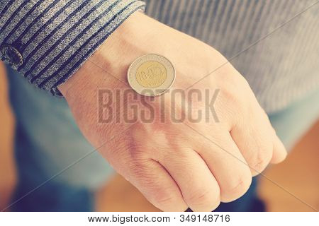 The Spanish Coin Lies On A Male Hand. The Game 
