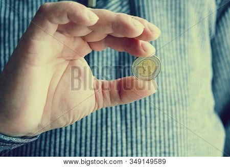 The Spanish Coin Lies On A Male Hand. The Game 
