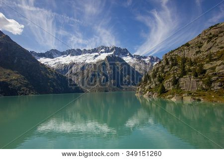 Reflection Of The Dammastock In The Lake At The Goescheneralp