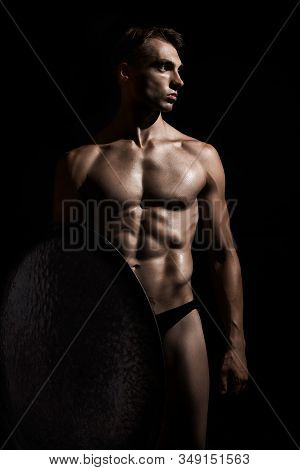 Front View Of Young Fit Strong Warrior With Perfect Muscular Body. Tensed Athlete In Underwear Looki
