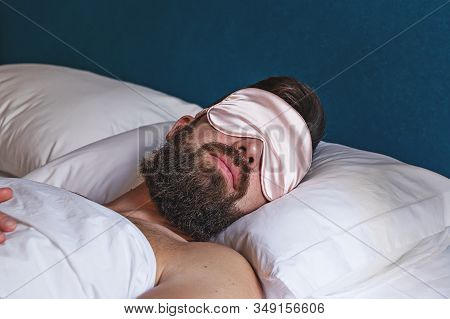 Closeup Portrait Of Bearded Man In Eyemask Sleeping In Bed. Concept Of Sleeping Mask Help By Insomni