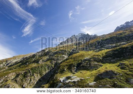 Mountains And Alps In Switzerland Under Blue Sky On A Sunny Summerday