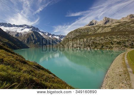 Lake Goeschenen At The Alp Goeschenen With The Dammastock On The Left Side