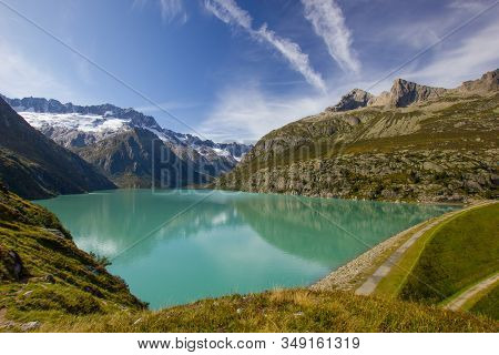 Lake Goeschenen In The Swiss Mountains With The Dam On The Rigth Side