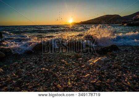 Orange Sunset Above Mediterranean Sea By The City Sarande In Albania