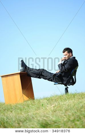 Business man at desk in nature