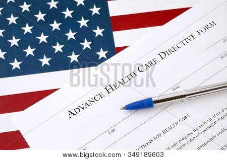 Advance Health Care Directive Blank Form And Blue Pen On United States Flag