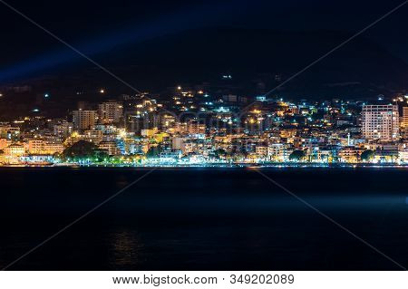 Night Photo Of Sarande In Albania In Background With Mediterranean Sea On Long Exposure