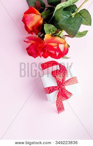 Gift Box With Bouquet Of Tred Rose On Pastel Pink Background