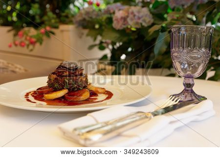 Tenderloin steak with foie gras and truffle, French dish served on summer patio