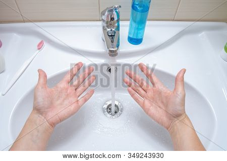 Woman Washing Hands Under The Faucet With Water, Hygiene And Profilactics Concept.