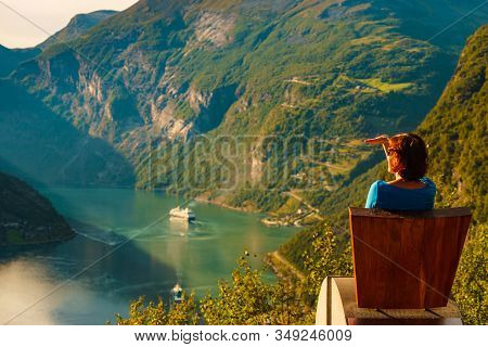 Tourism Vacation And Travel. Female Tourist Enjoying View Over Geirangerfjord From Flydalsjuvet View