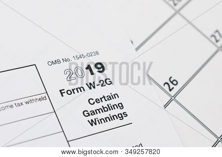 Irs Form W-2g Certain Gambling Winning Blank Lies On Empty Calendar Page