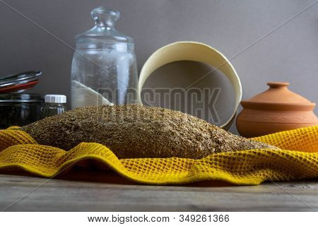 Oatmeal Diet Bread On A Yellow Towel In The Background Is Satiated For Flour, A Jar Of Flour, And A 