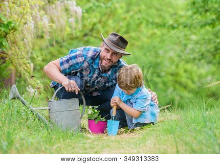 Boy And Father In Nature With Watering Can. Gardening Tools. Planting Flowers. Dad Teaching Little S