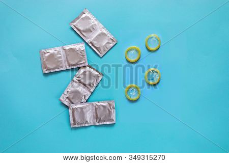 Group Of A Condom On A Blue Background, Flat Lay